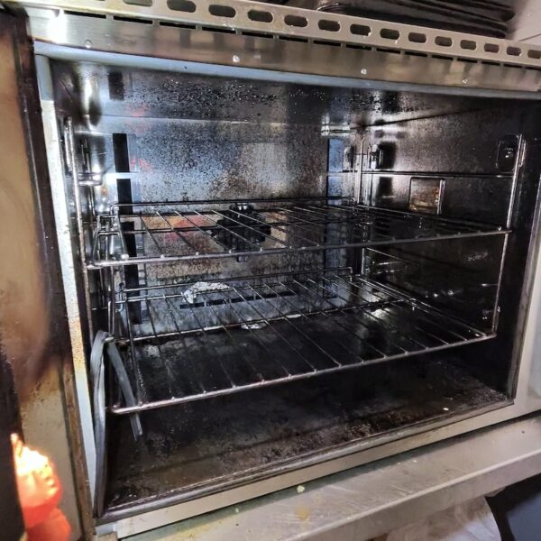 Buffalo commercial oven with heavy grease and burnt-on carbon before professional cleaning in a Tamworth deli.