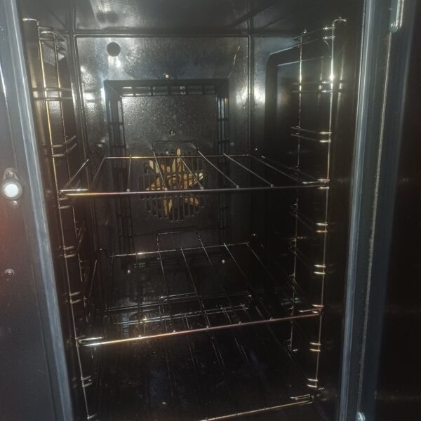 Tall oven interior of the Rangemaster Professional in Hopwas, showing cleaned enamel, shelf runners and wire shelves.